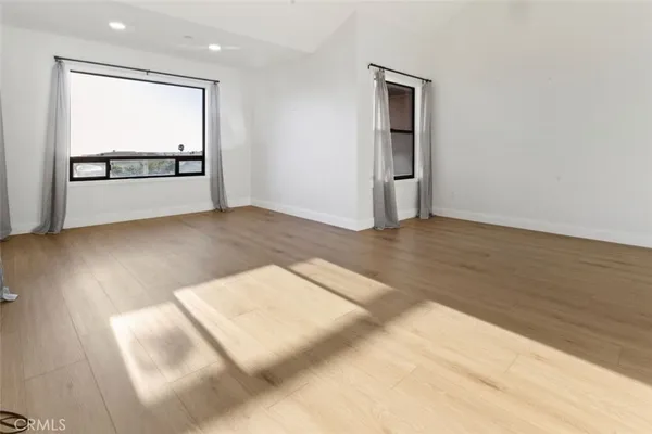 a kitchen with stainless steel appliances granite countertop a refrigerator a stove and a sink with cabinets