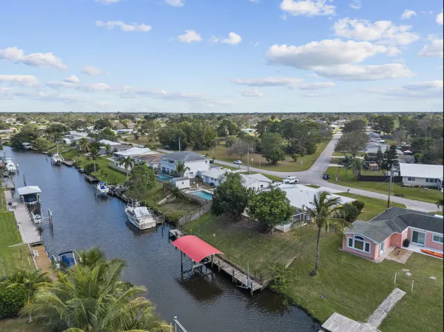 a kitchen with a sink a stove top oven and cabinets