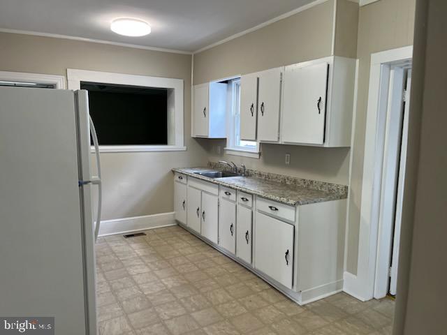 3905 Arden Road Richmond, VA 23222 - Photo 2 of 8 a bathroom with a granite countertop sink and white cabinets