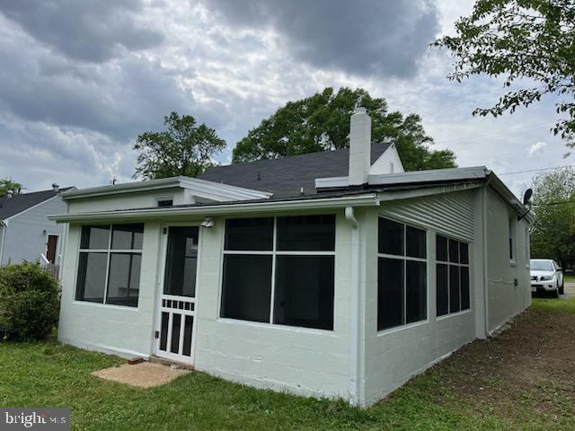 3905 Arden Road Richmond, VA 23222 - Photo 7 of 8 a view of a white house with a big yard and potted plants