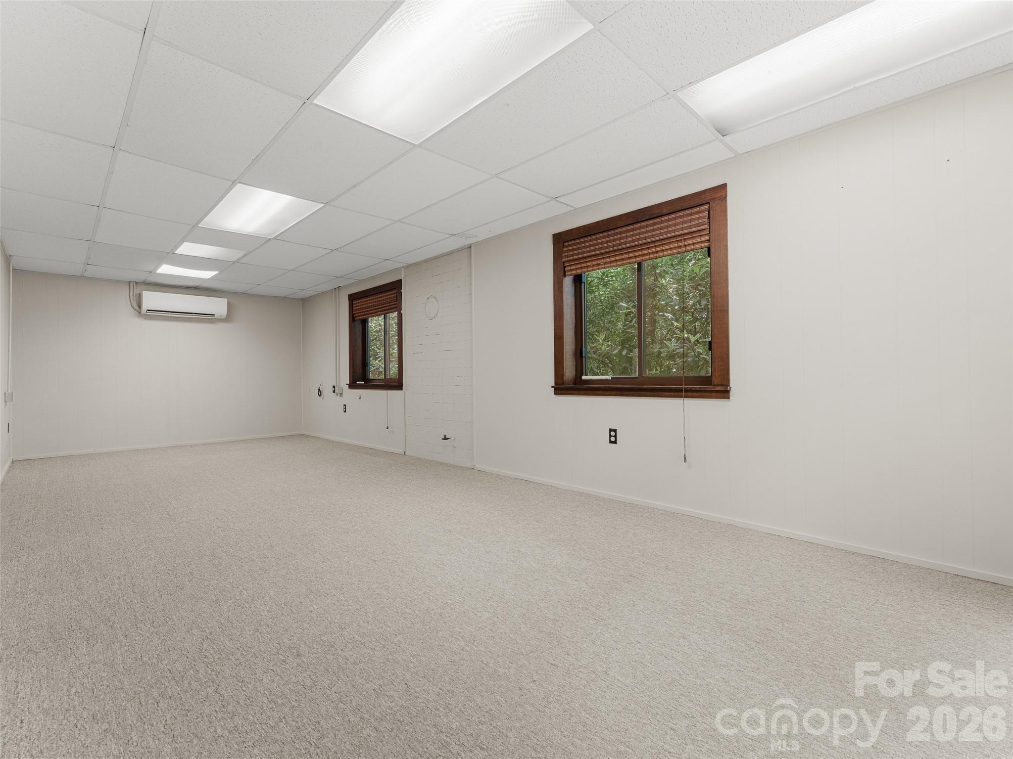 32 Honey Suckle Ridge Road Pisgah Forest, NC 28768 - Photo 27 of 35 an empty room with windows