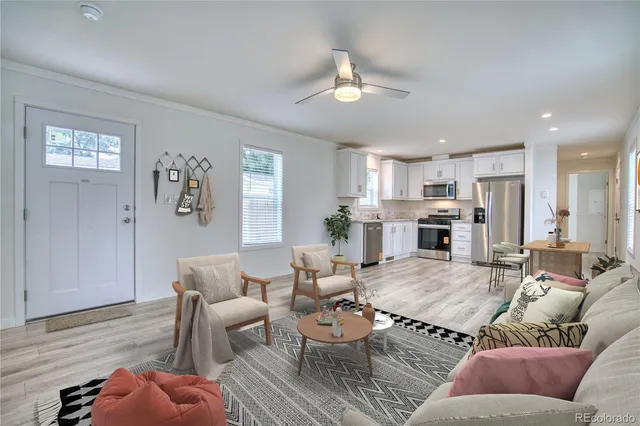 a living room with furniture kitchen and a table