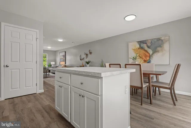 a kitchen with a sink cabinets and wooden floor