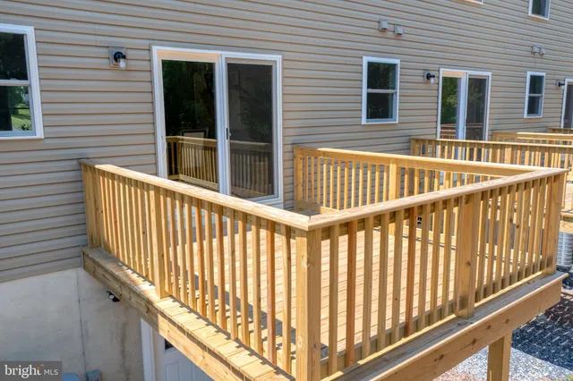 a view of a balcony with a floor to ceiling window and wooden fence