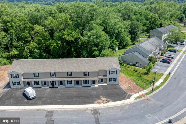 an aerial view of a house with yard