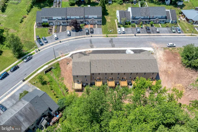an aerial view of a house with a garden and plants