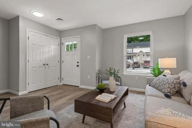 a living room with furniture and wooden floor