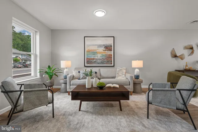 a living room with furniture potted plant and a window