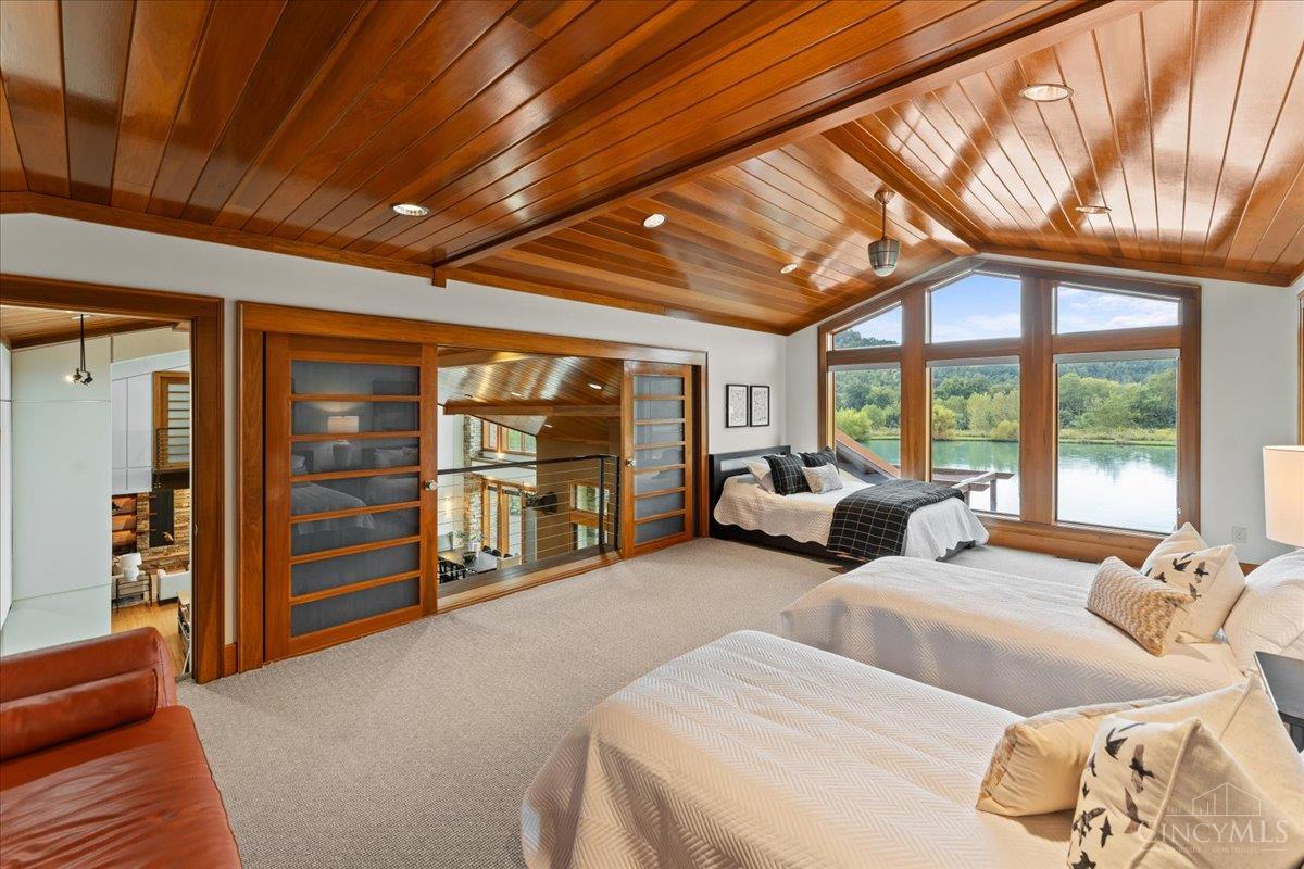 1805 Waggoner Riffle Road West Union, OH 45693 - Photo 41 of 90 Loft-Style Bedroom Suite. An expansive lofted bedroom with oversized sliding doors that open the space to the home’s dramatic architecture. Designed with flexibility in mind, there’s room for multiple beds—perfect for family, guests or a bunk-room-style retreat.