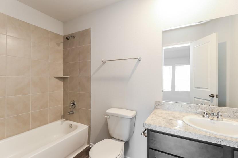 113 Arango Way Everman, TX 76140 - Photo 9 of 13 a bathroom with a sink toilet and shower