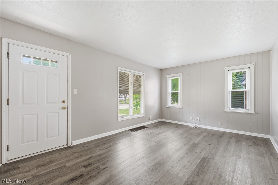 311 Fowles Road Berea, OH 44017 - Photo 4 of 40 Spacious interior featuring wood-finish flooring, light grey painted walls, and white trim