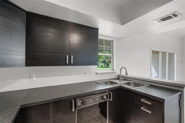 a kitchen with a sink and a window