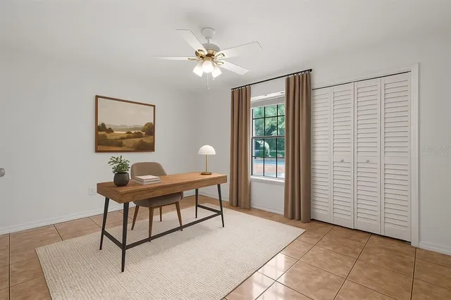 a view of a workspace with furniture and a window
