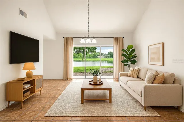 a living room with furniture a flat screen tv and a large window