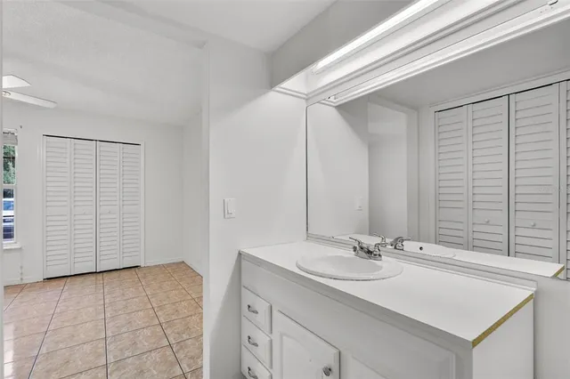 a bathroom with a sink a vanity and a mirror