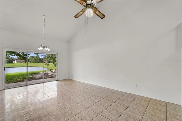 a view of a room wooden floor and a chandelier