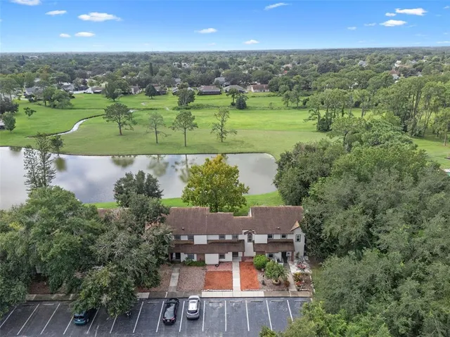 an aerial view of a house with a yard and lake view