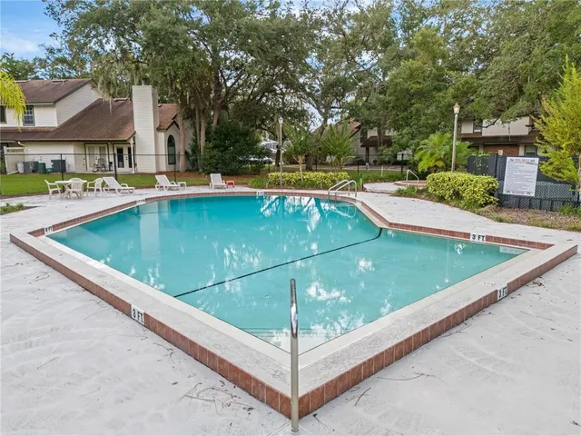 a view of a swimming pool with a patio