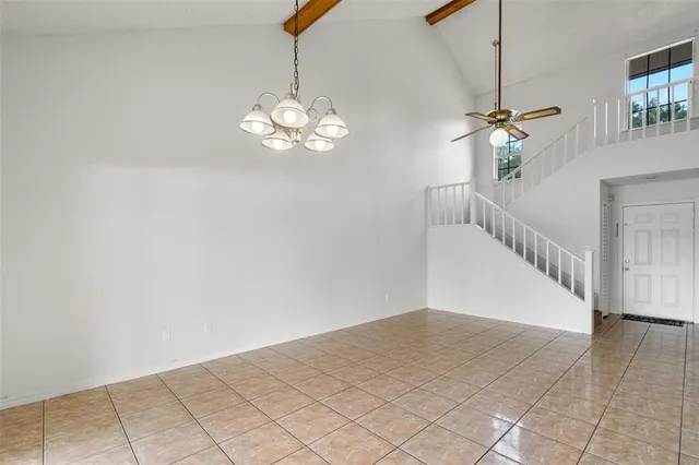a view of a chandelier fan and entryway