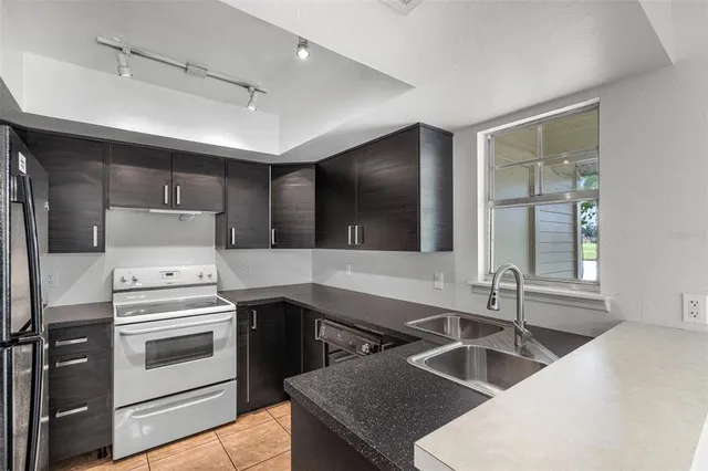 a kitchen that has a sink and a stove in it