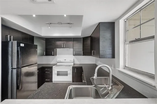 a kitchen with a refrigerator and a sink