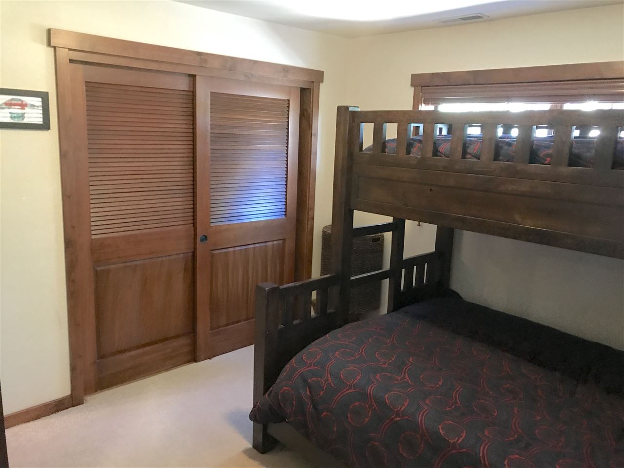 334 Davison Road Mammoth Lakes, CA 93546 - Photo 11 of 15 a bedroom with a bed and a chandelier