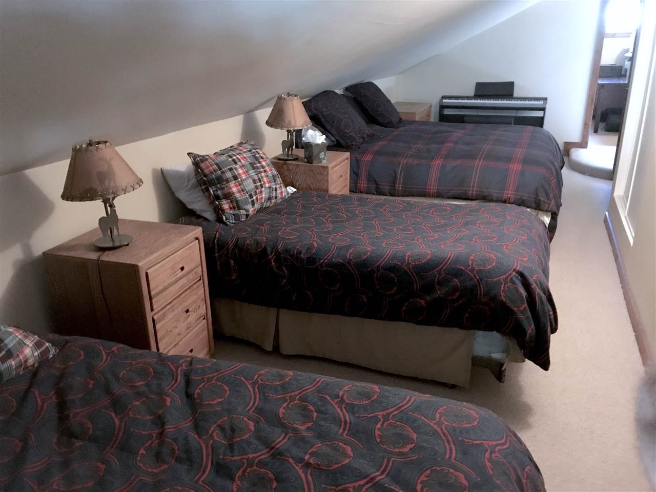 334 Davison Road Mammoth Lakes, CA 93546 - Photo 12 of 15 a bed sitting in a bedroom next to a lamp