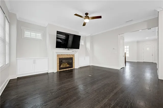 a view of a room with wooden floor and windows