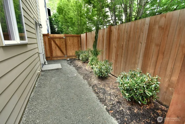a view of a chair and table in backyard of the house