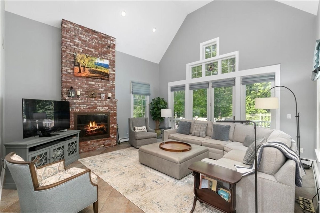 9 Perley Lane Boxford, MA 01921 - Photo 14 of 41 a living room with furniture a fireplace and a flat screen tv