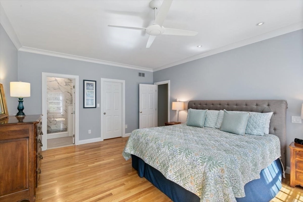 9 Perley Lane Boxford, MA 01921 - Photo 19 of 41 a bedroom with a large bed and a chandelier