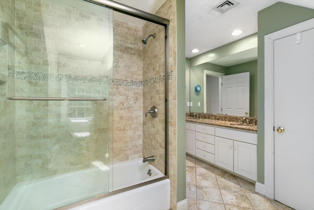 9 Perley Lane Boxford, MA 01921 - Photo 30 of 41 a bathroom with a granite countertop shower mirror and a bathtub