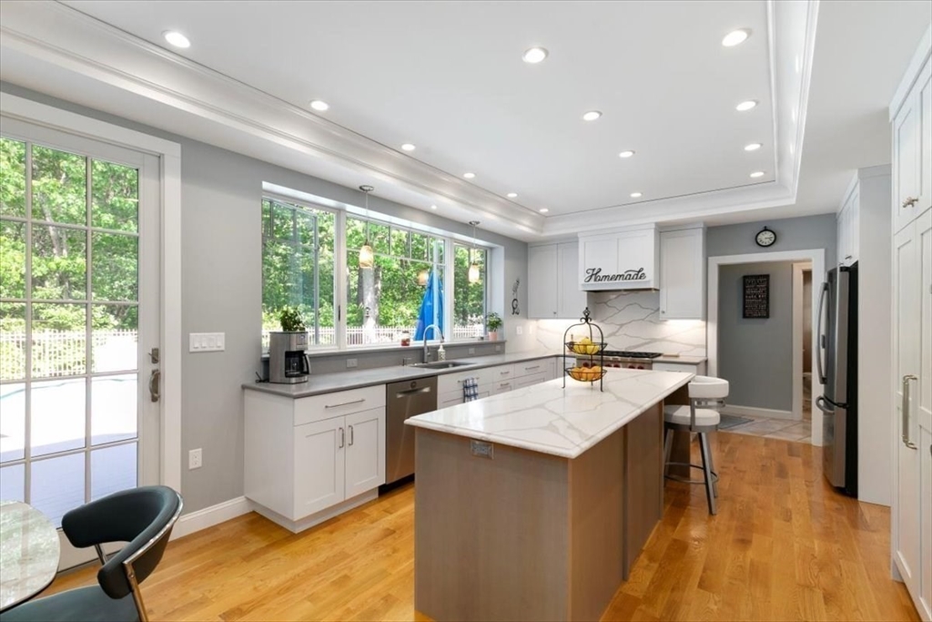 9 Perley Lane Boxford, MA 01921 - Photo 8 of 41 a kitchen with a sink and chairs