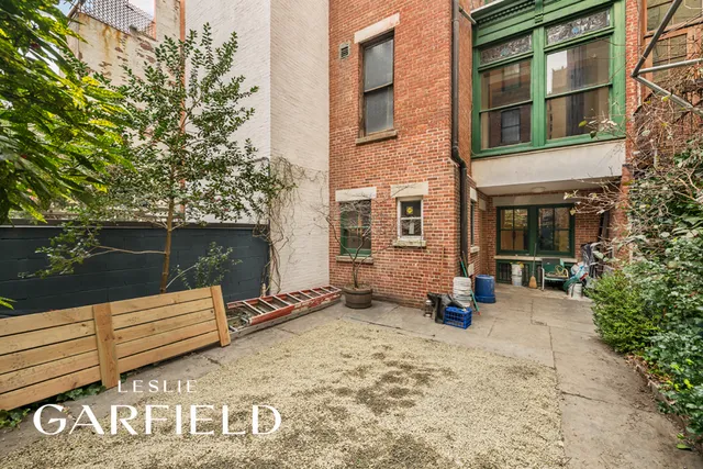 a wooden bench sitting in front of a building