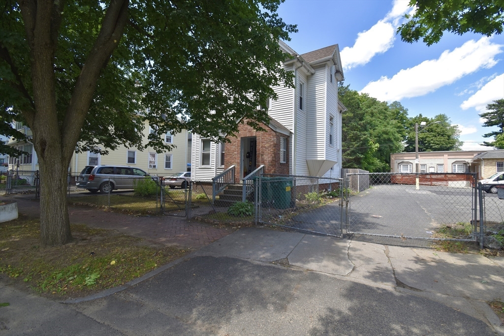 98 Alderman Street Springfield, MA 01108 - Photo 3 of 20 a view of a street with a large tree