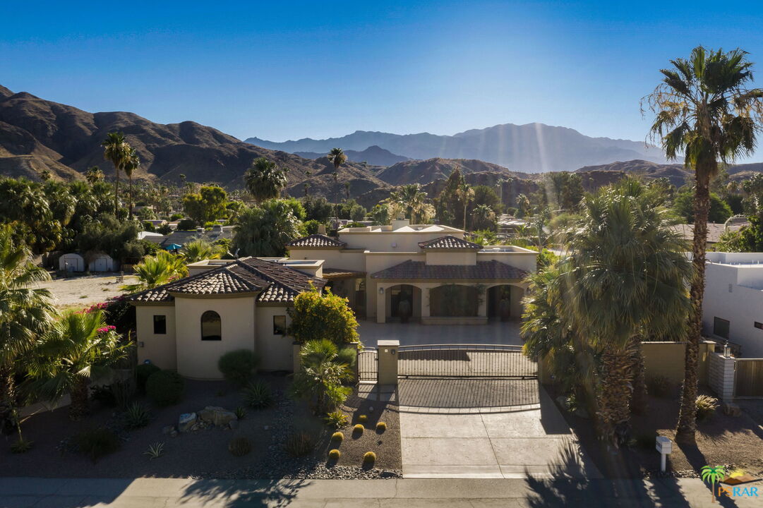 a front view of a house with a mountain