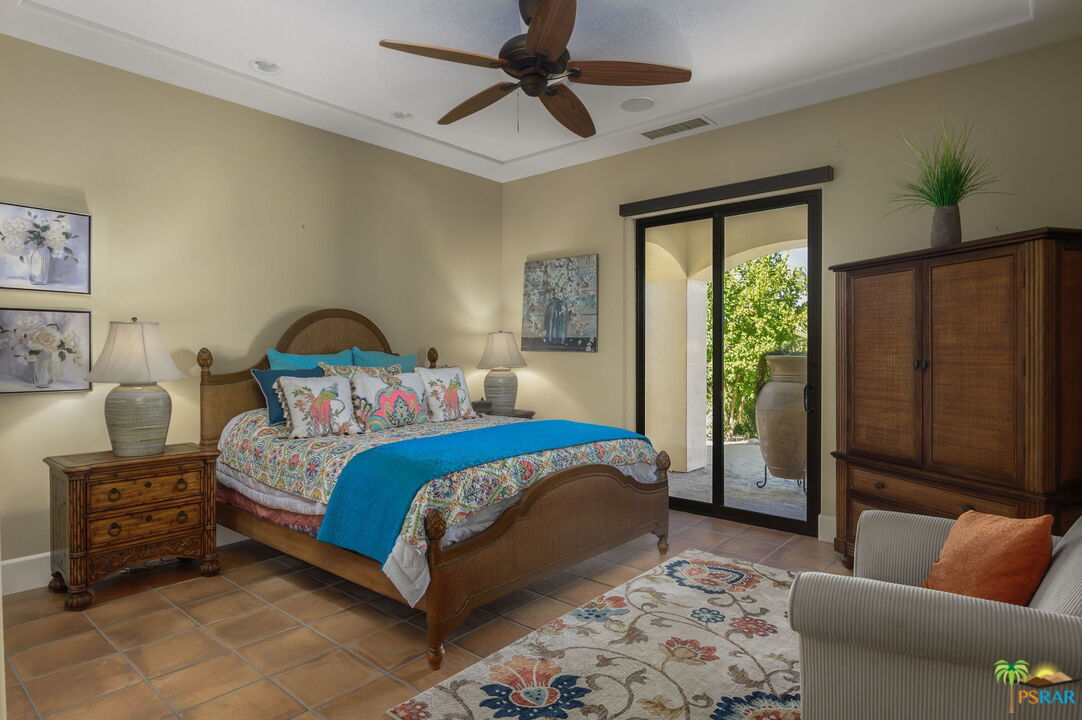 38851 Nielson Road Rancho Mirage, CA 92270 - Photo 15 of 50 a bedroom with a bed a couch and a window