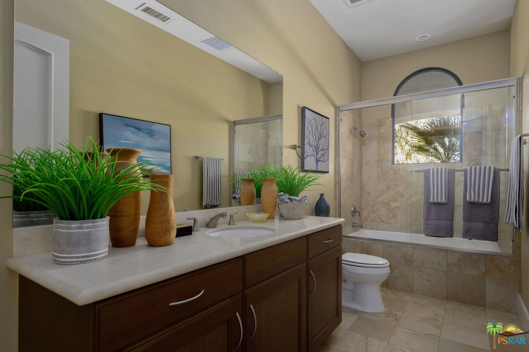 38851 Nielson Road Rancho Mirage, CA 92270 - Photo 17 of 50 a bathroom with a granite countertop sink a toilet a mirror and shower