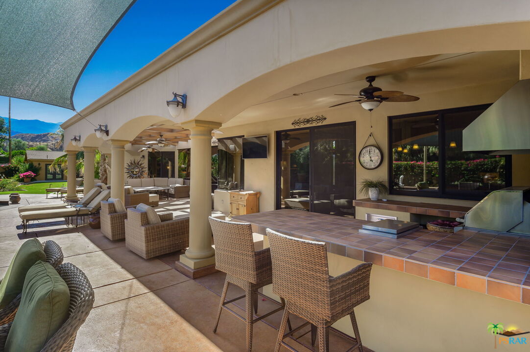 38851 Nielson Road Rancho Mirage, CA 92270 - Photo 22 of 50 a large living room with stainless steel appliances granite countertop furniture and a fireplace