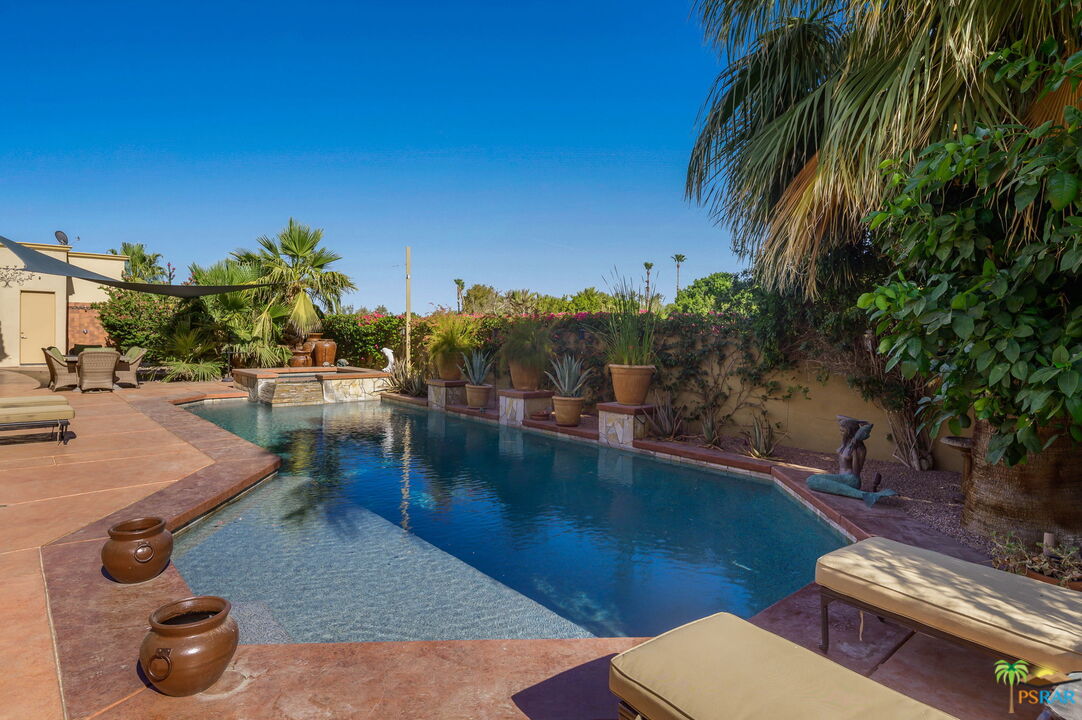 38851 Nielson Road Rancho Mirage, CA 92270 - Photo 26 of 50 a view of a backyard with plants and lake view