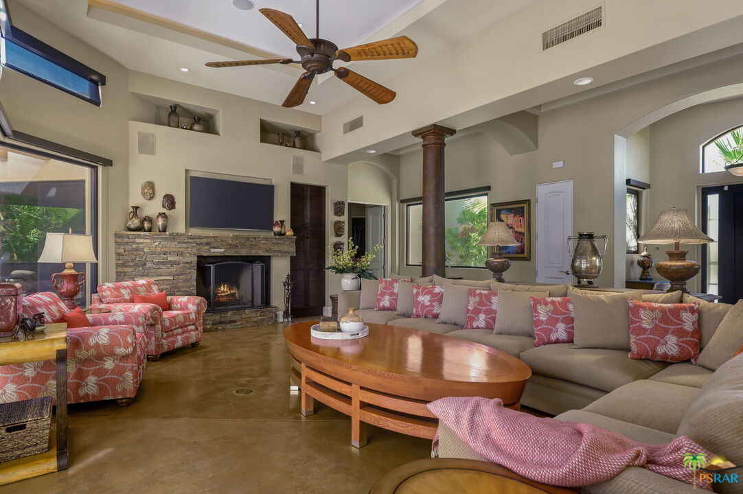 38851 Nielson Road Rancho Mirage, CA 92270 - Photo 5 of 50 a living room with furniture a flat screen tv and a fireplace