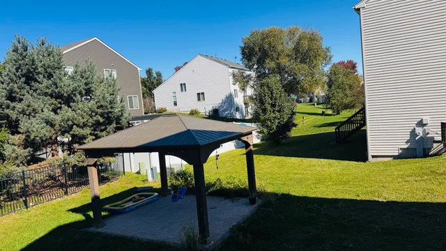 a view of a house with backyard and sitting area