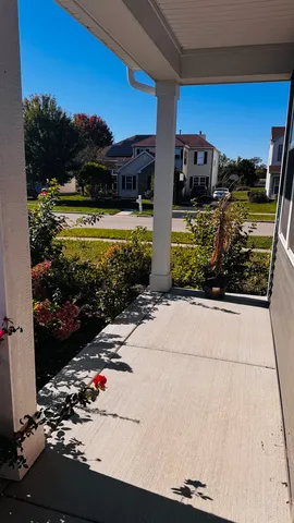 a view of a patio with a table and chairs under an umbrella