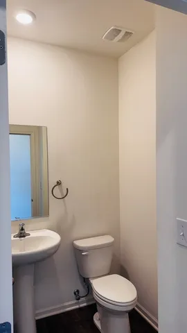 a bathroom with a sink a mirror and a toilet