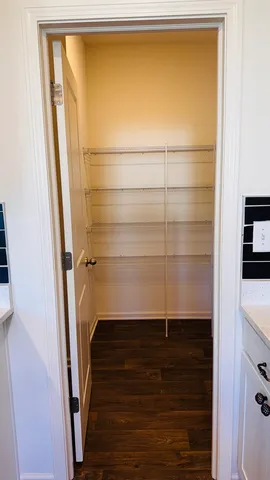 a view of storage and utility room with wooden floor