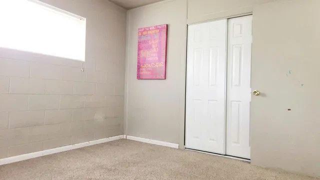 a bathroom with a painting on the wall