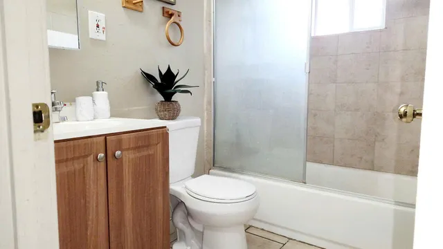 a bathroom with a sink a toilet and shower
