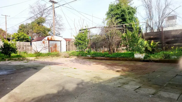 a view of a house with a yard and pathway