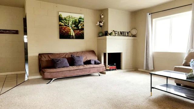 a living room with furniture and a fireplace
