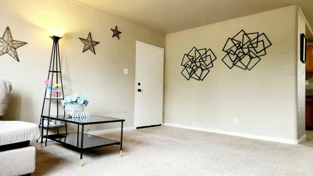 a living room with a white couch and a potted plant